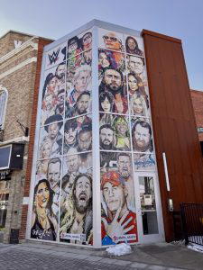 Local artist JD Bills painted a mural featuring past and present WWE superstars who have participated in the Royal Rumble Match. For more on JD Bills visit his website at https://www.JDBills.com/.