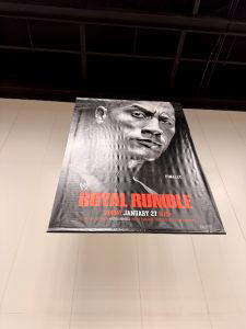 The poster for "WWE Royal Rumble 2013" hung above the superstore.