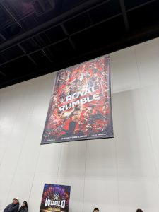The poster for "WWE Royal Rumble 2022" hung above the superstore.