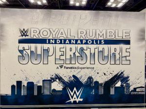 A graphic featuring the WWE Royal Rumble Superstore logo above the downtown Indianapolis skyline.