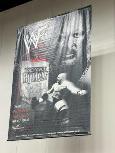 The poster for "WWF Royal Rumble 1999" hung above the superstore.
