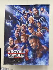 The poster for "WWE Royal Rumble 2023" hung above the superstore.