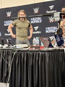 "Prince Pretty" Tyler Breeze and Big E arrive at the WWE/Fanatics auction table.